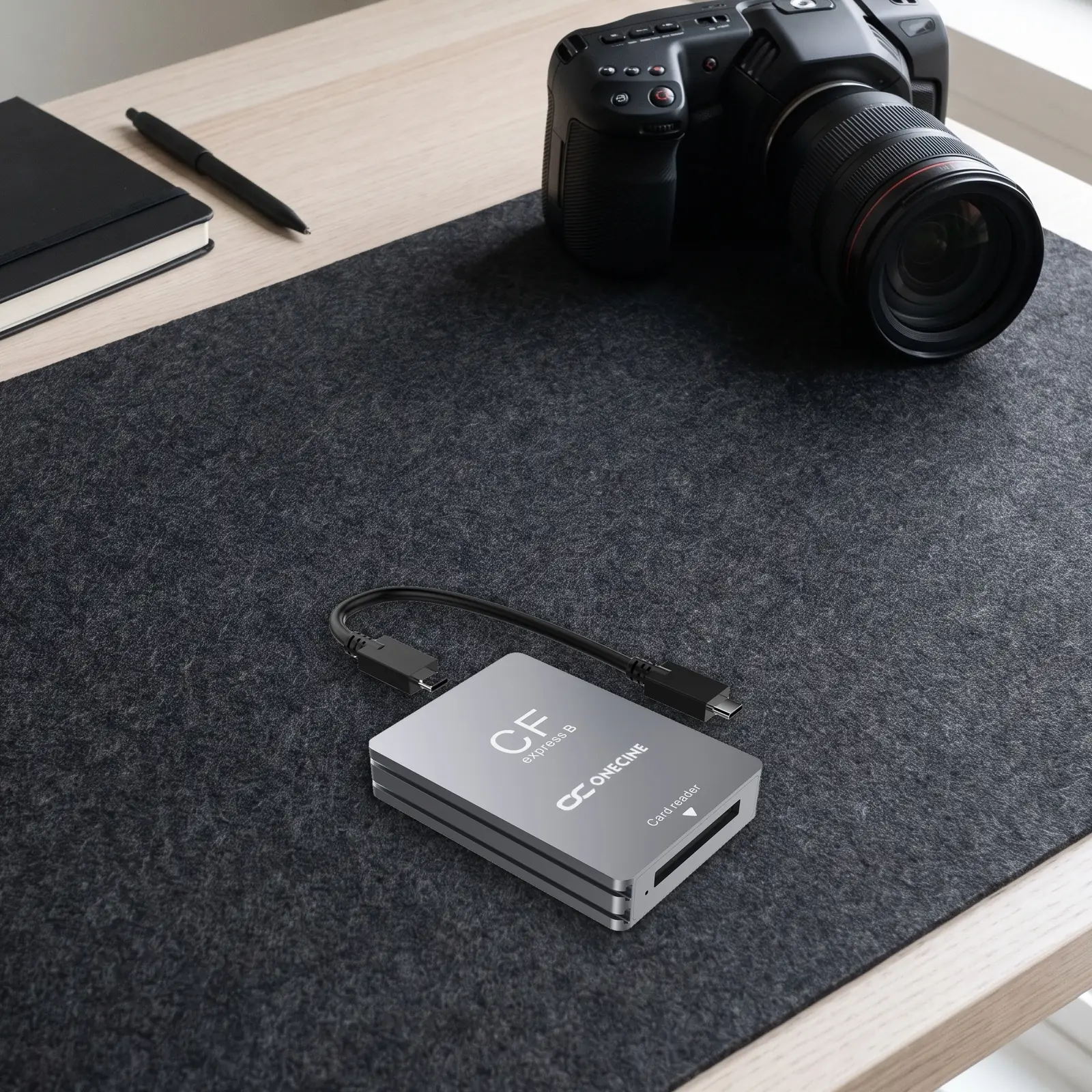 Картридер OneCine CFexpress Type B с кабелем USB-C на столе видеографа рядом с кинокамерой