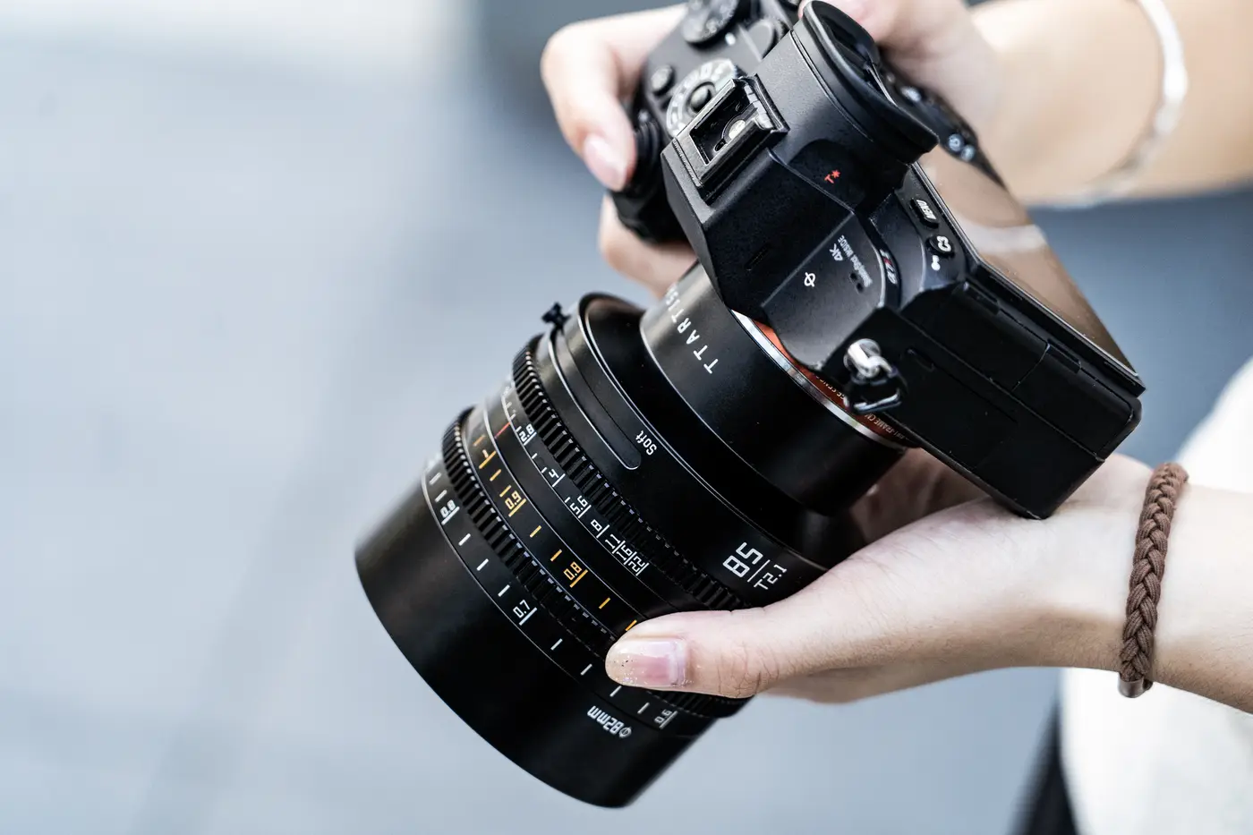 Кинообъектив TTArtisan 50 мм T2.1 в руках на камере Panasonic S
